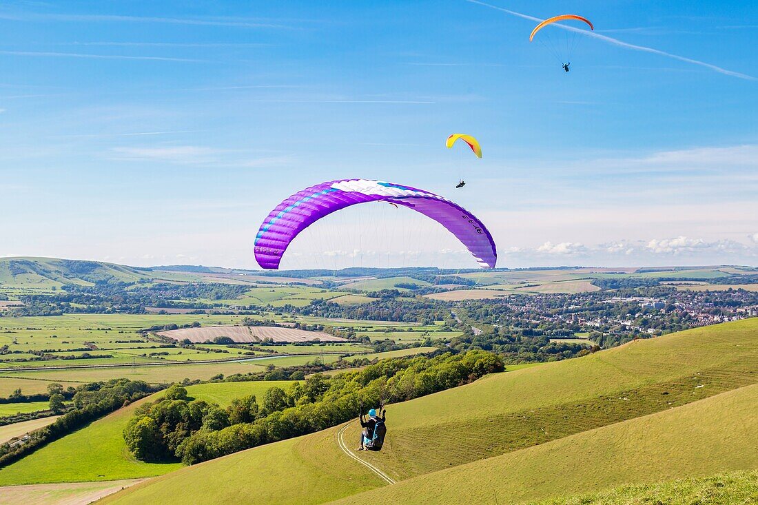 Paragliders at Mount Caburn, flying over the County town of Lewes, East Sussex, England, United Kingdom, Europe