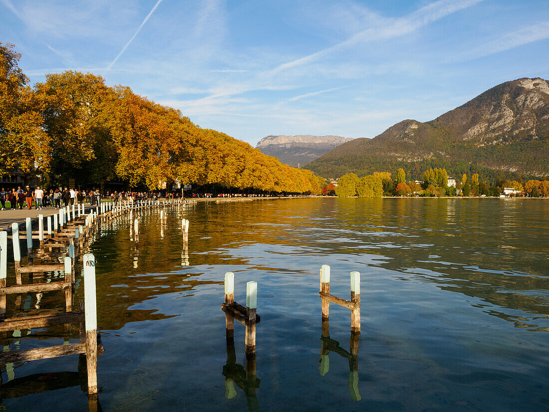 Mountains and fall color on Lake Annecy shoreline promenade, Annecy, Haute-Savoie, France, Europe