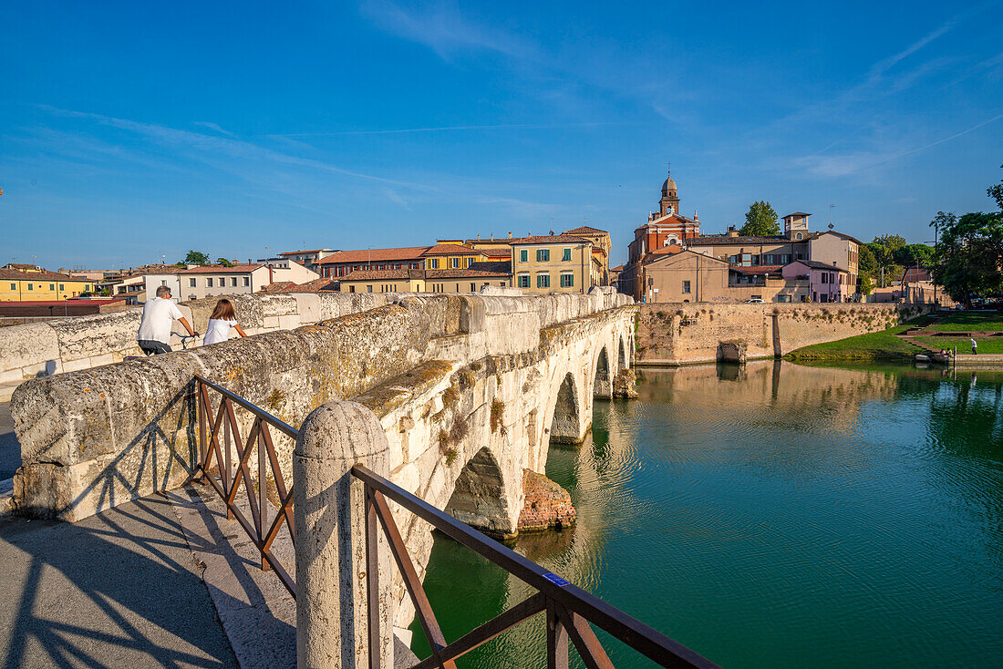 View of Ponte di Tiberio reflecting in Rimini Canal from Borgo San Giuliano, Rimini, Emilia-Romagna, Italy, Europe