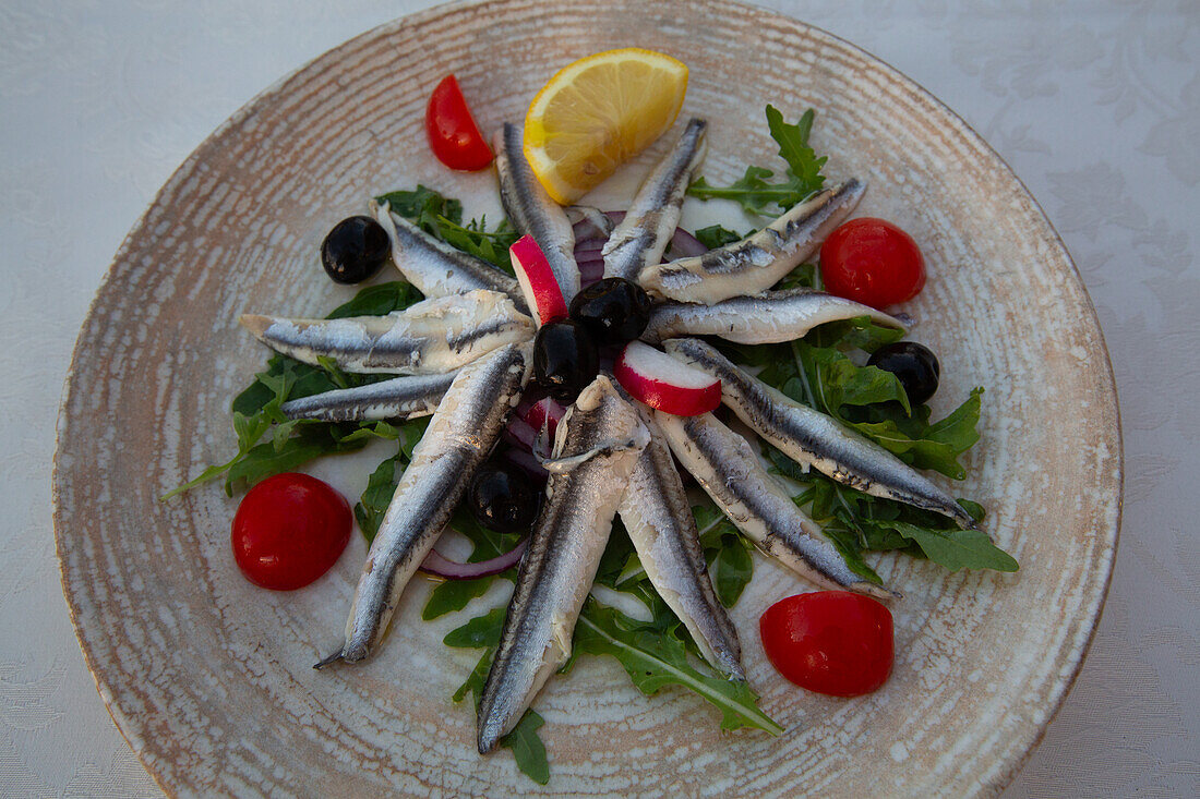 Food dish of Marinated Anchovies with Cherry Tomatoes and Olives, Restaurant, Old Town, Novigrad, Croatia, Europe
