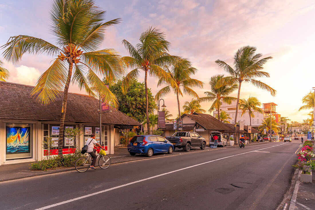 View of palm trees and boutique shops in Grand Bay at sunset, Mauritius, Indian Ocean, Africa