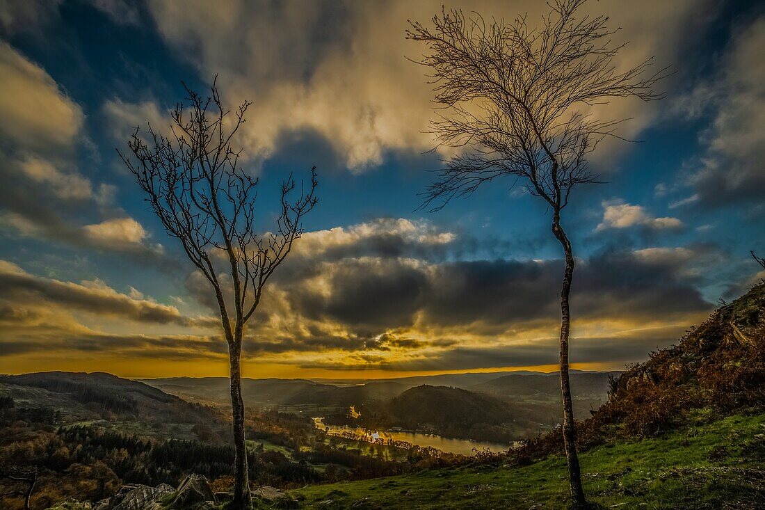 Sunset view from Gummers How in the Lake District, UNESCO World Heritage Site, across Windermere towards the distant Cumbrian Coast and Furness Peninsula, Cumbria, England, United Kingdom, Europe