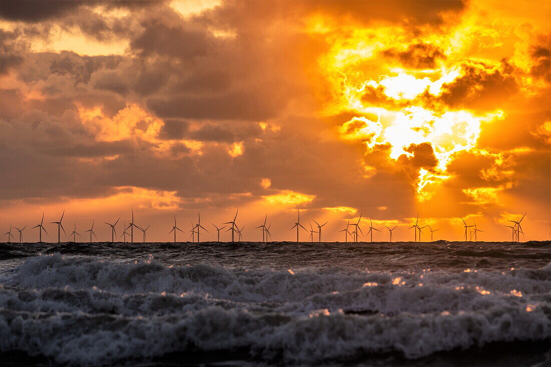 Sunset view from Walney Island across the Irish Sea towards the distant Walney Offshore Wind Farm, Cumbrian Coast, Cumbria, England, United Kingdom, Europe