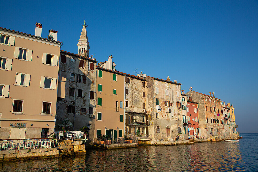 Buildings on the waterfront and Tower of Church of St. Euphemia behind, Old Town, Rovinj, Croatia, Europe