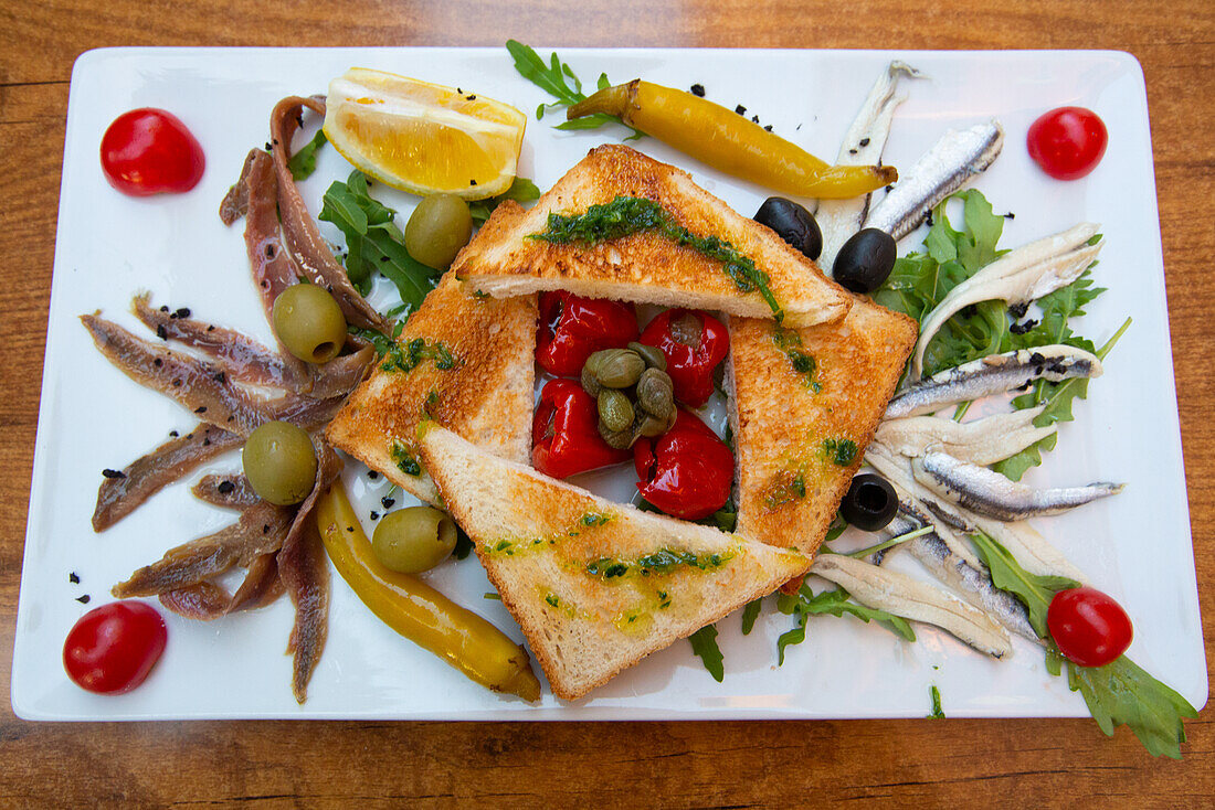 Food Plate of Marinated and Salted Anchovies with Cherry Tomatoes, Olives, Stuffed Miniature Bell Peppers and Toast, Pula, Croatia, Europe