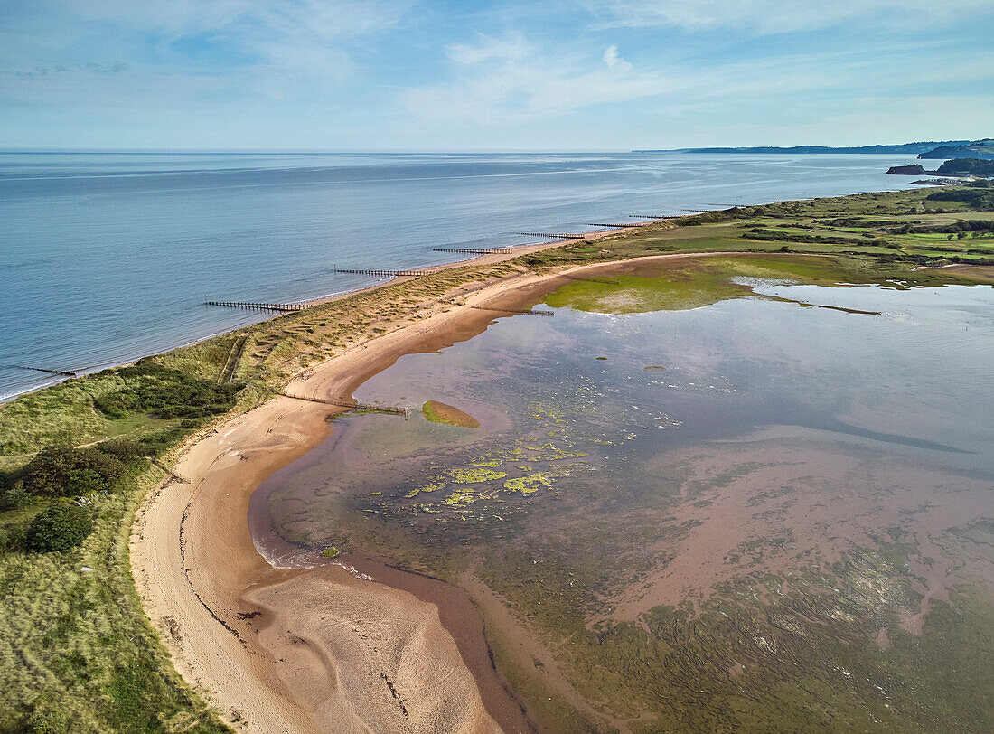 Aerial view of beach and dunes at Dawlish Warren, guarding the mouth of the River Exe, looking south along the coast towards the town of Dawlish, Devon, England, United Kingdom, Europe