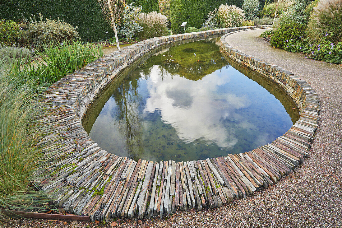 Eine formale Gartenszene, mit Teich, in Devon, England, Vereinigtes Königreich, Europa