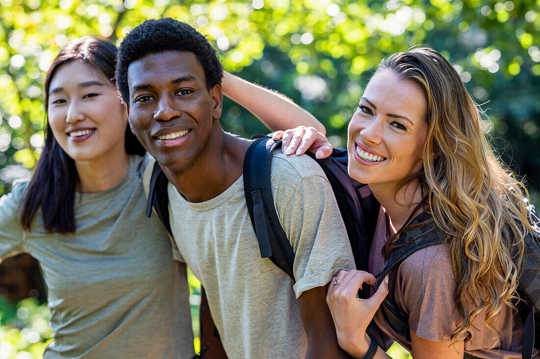 Portrait of three friends looking at the camera during hiking excursion