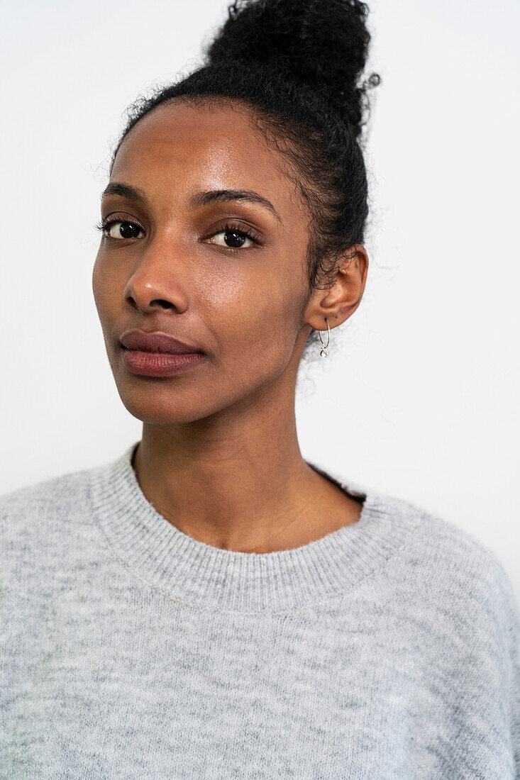 Front view portrait of woman looking at the camera with white background