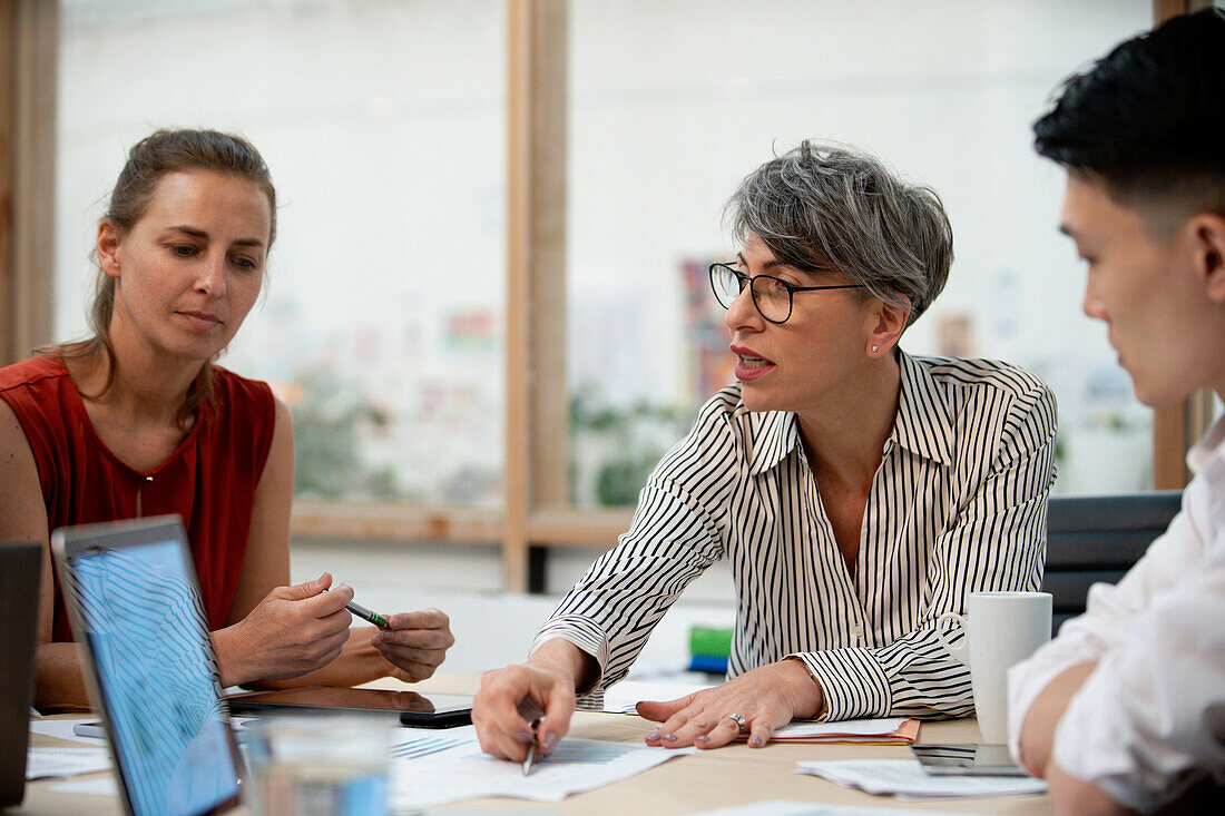 Businesswoman discussing project with coworkers