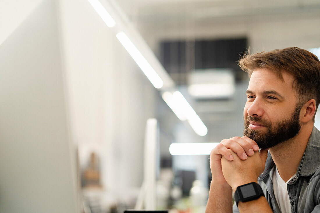 System engineer watching at computer monitor