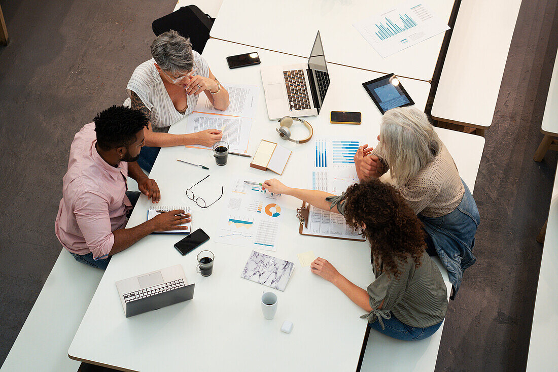 Group of accountants discussing over paperwork