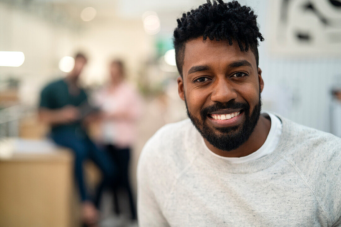 Cheerful African American coworker looking at the camera