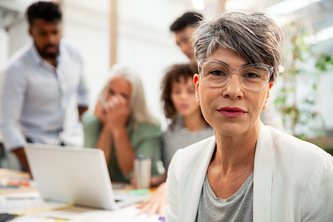 Female agency manager looking at the camera during meeting