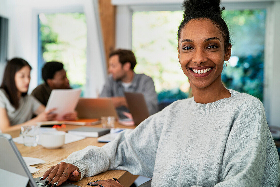 Female accountant looking at the camera while working at desk