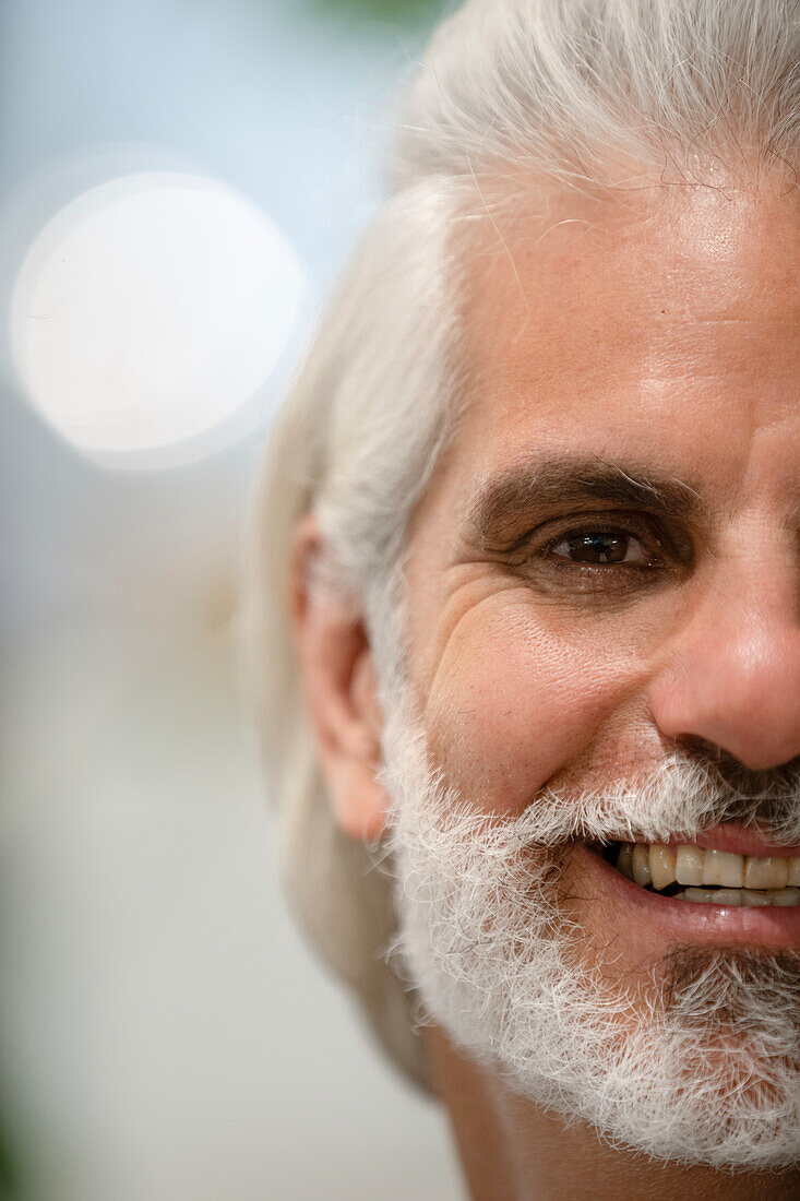 Portrait of half face of adult man looking at camera