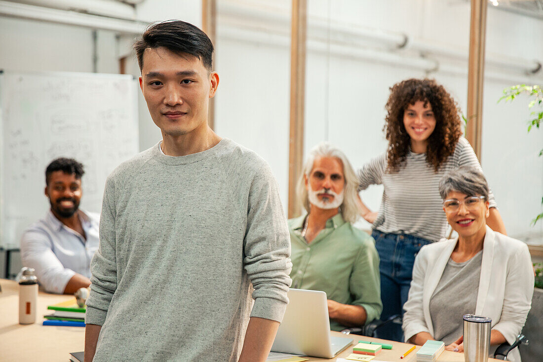 Graphic designer standing in office while looking at the camera