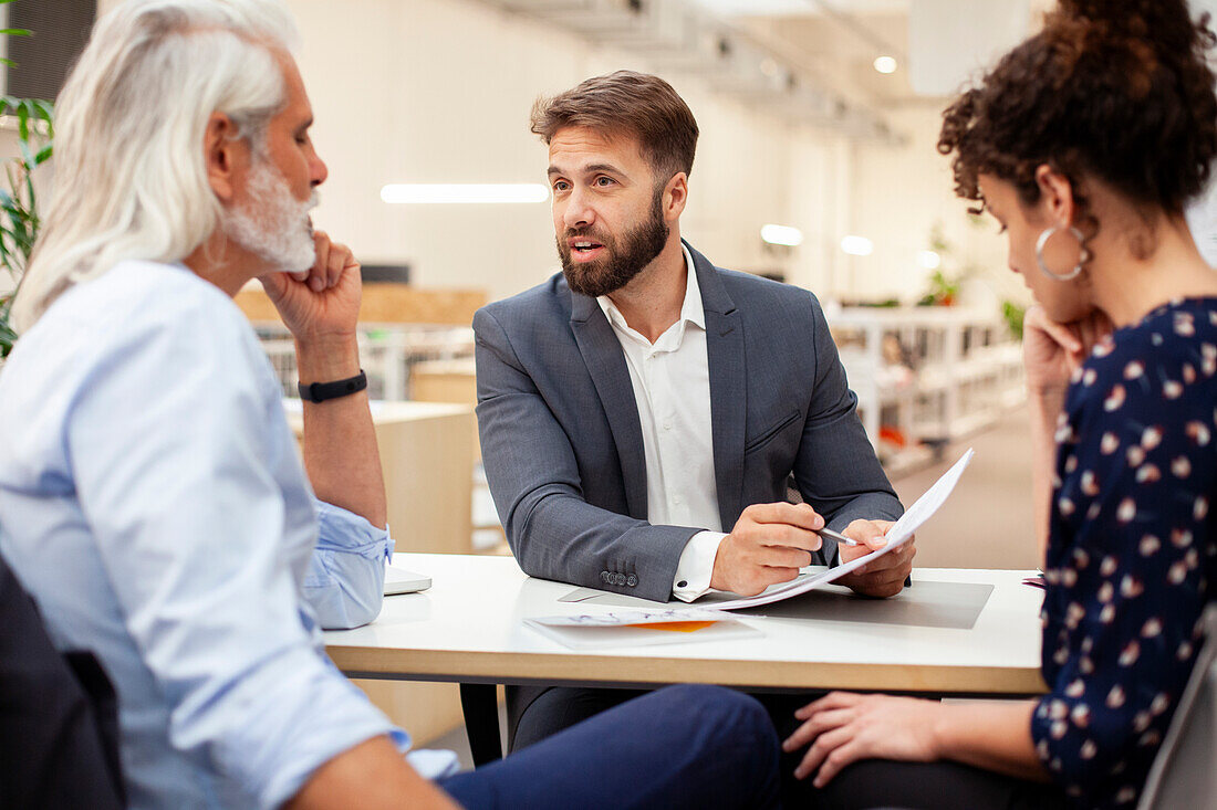 Financial advisor discussing over contract with clients