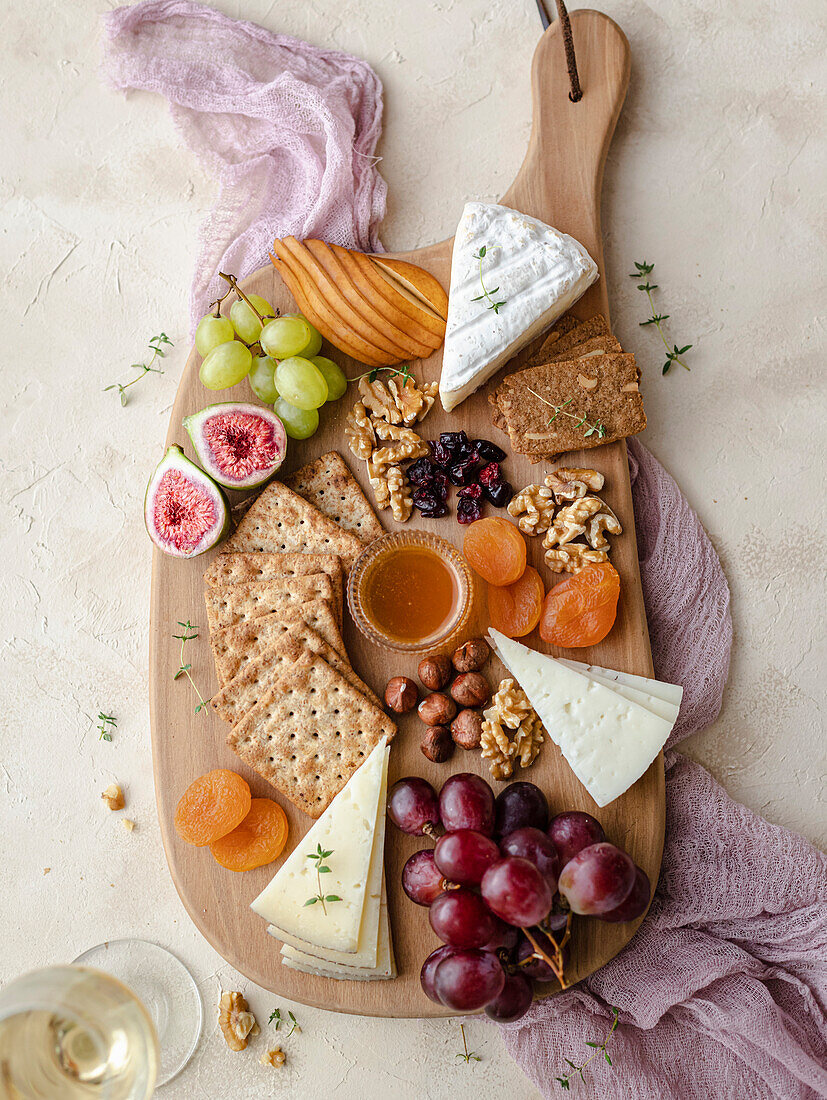 Autumn cheeseboard with a cup of white wine