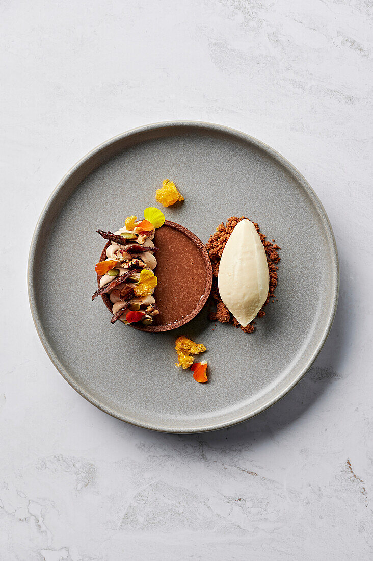 Kürbiskuchen mit Schokolade und Gewürzen, gebutterten Pekannüssen, gesalzenen Schokoladenstreuseln und Beurre Noisette-Eis