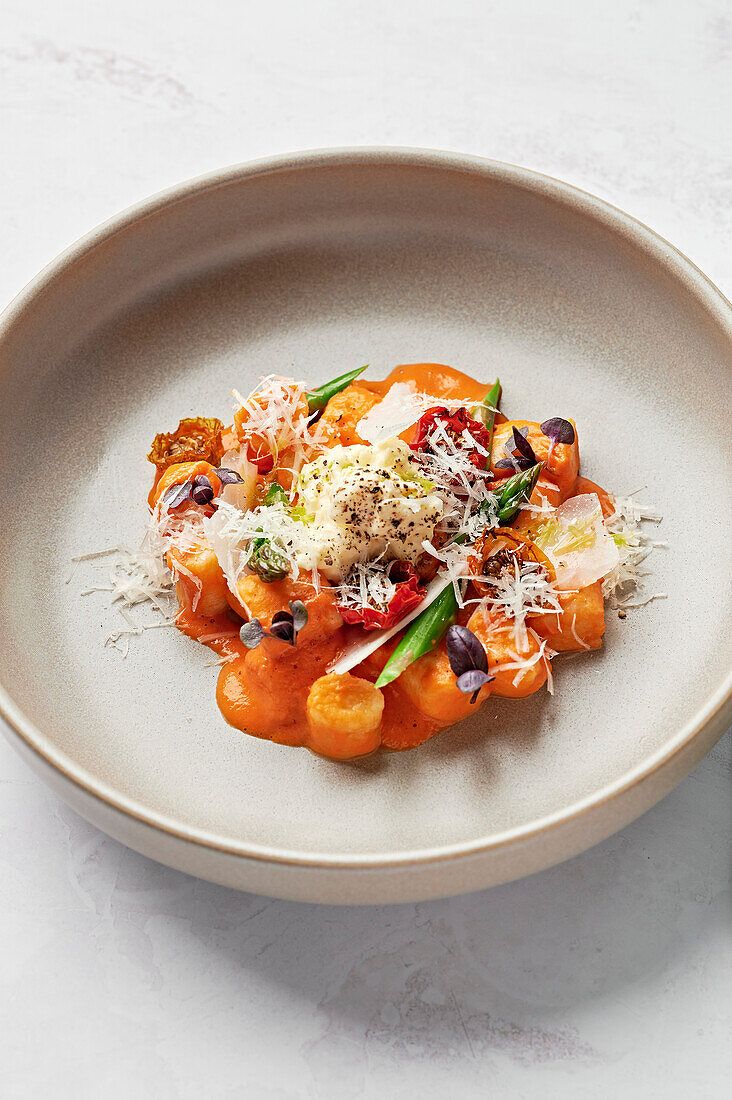 Gnocchi, tomato emulsion, roasted cherry tomatoes, asparagus spears, stracciatella, parmesan, purple basil