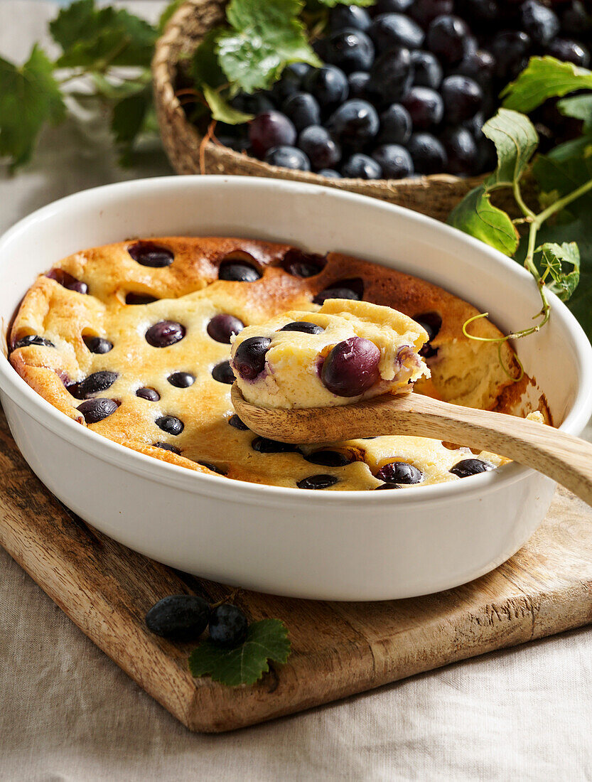 Red grape clafoutis, French cuisine. on a ceramic tile table with blue pattern
