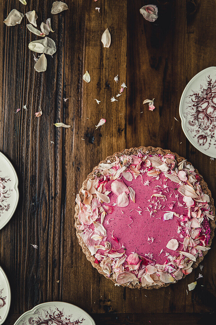 A vegan pink cake on a rustic wooden background
