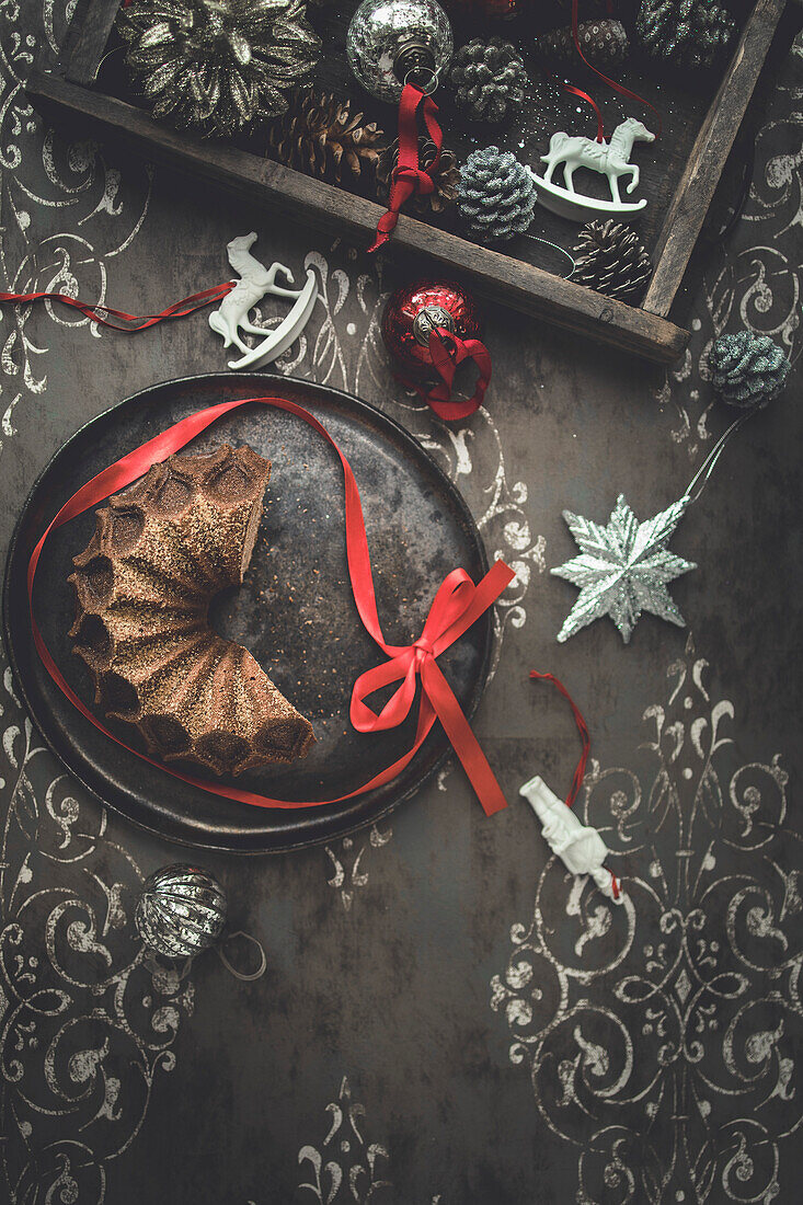 Christmas cake with Christmas decorations on a patterned background