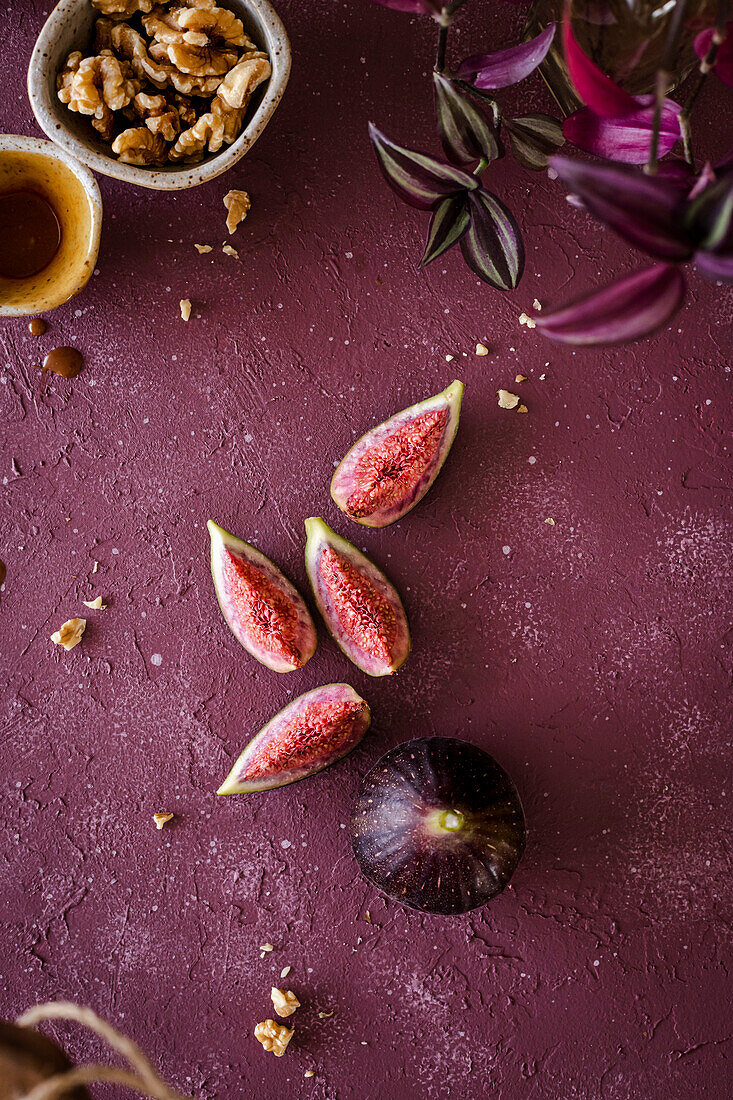 Ripe fig slices on a warm purple background