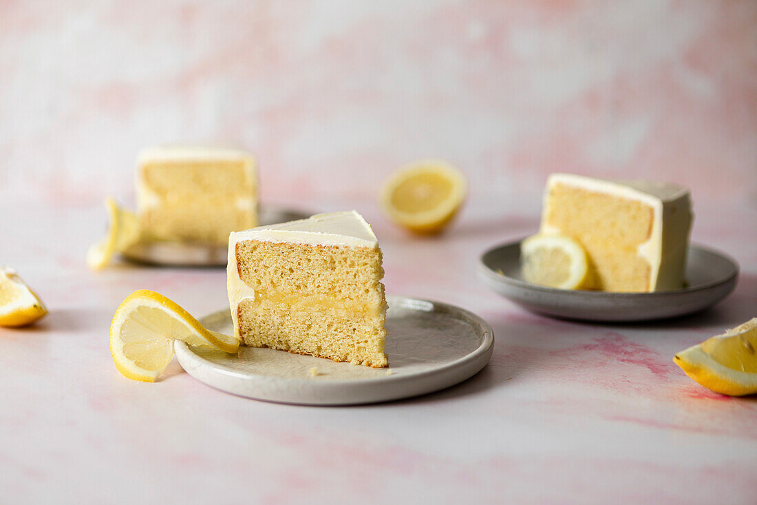 Slice of lemon meringue cake on a white plate