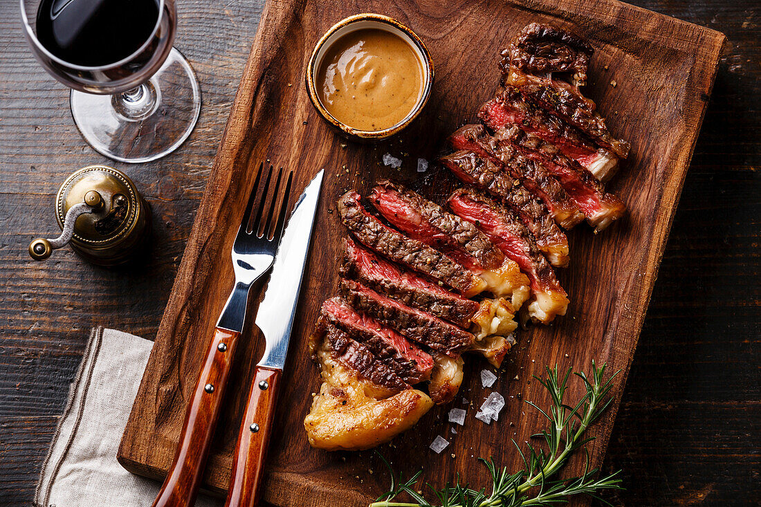 Grilled steak striploin with pepper sauce close-up