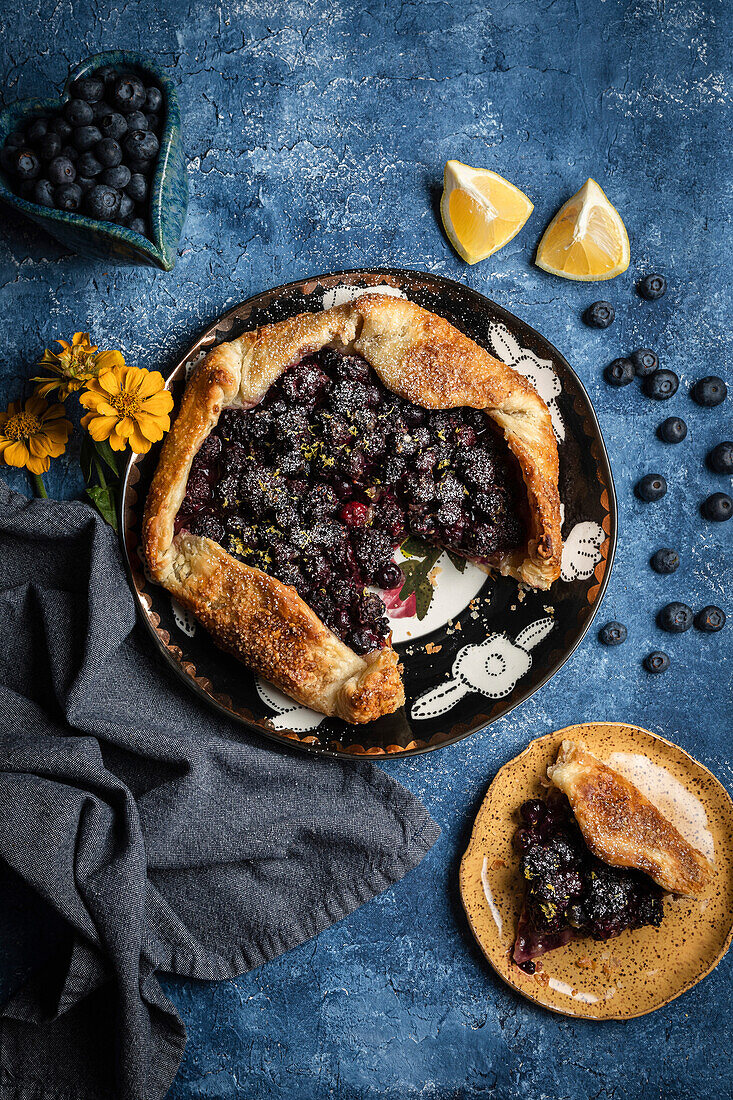 Blueberry and blackberry galette on a blue background