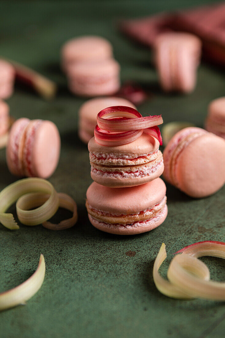 Rhubarb macarons on a green background