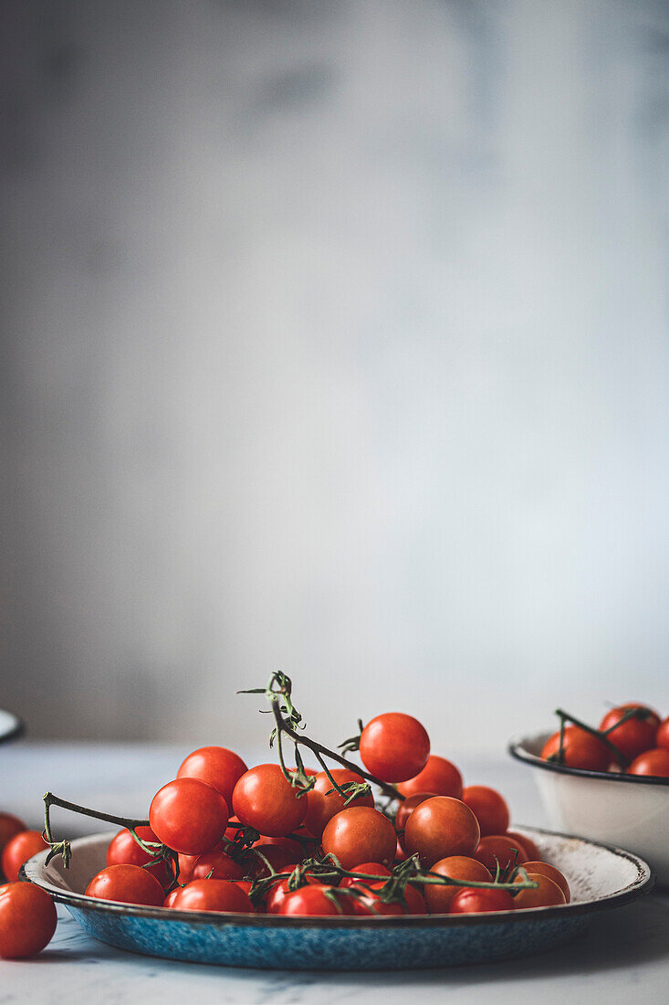 Tomatoes on the vine on a table with a copy surface