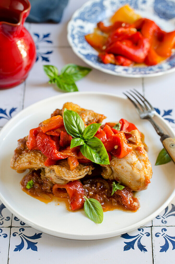 Chicken and peppers served with basil leaves