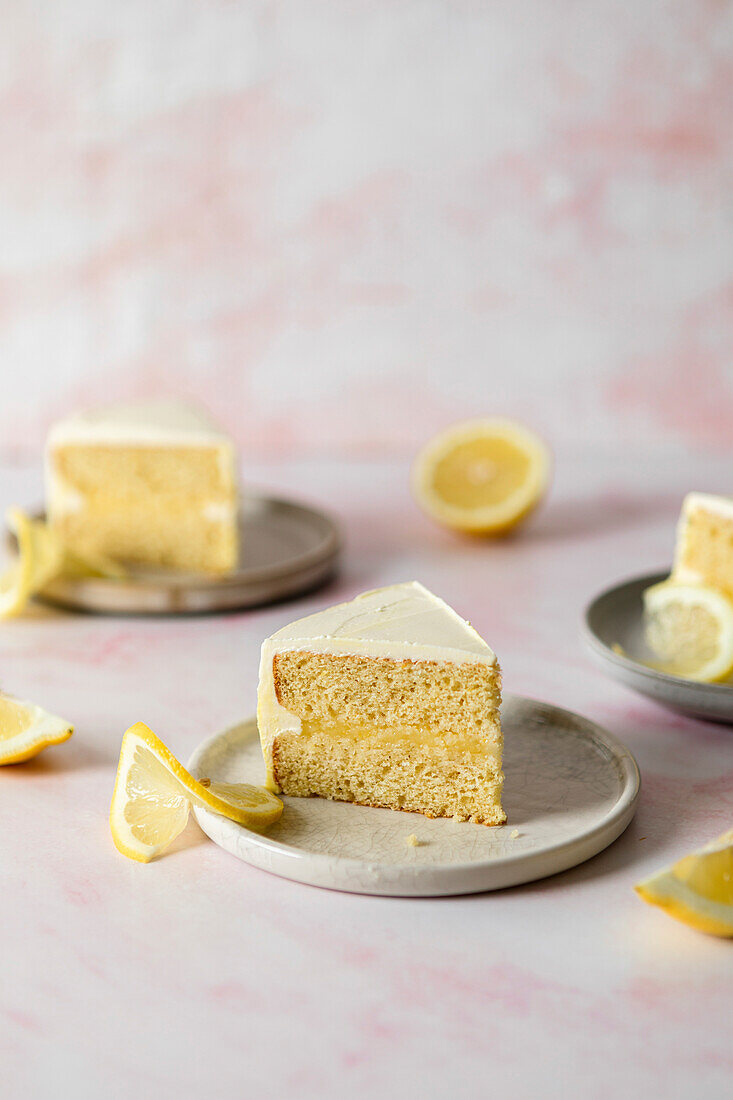 Slice of lemon meringue cake on a white plate