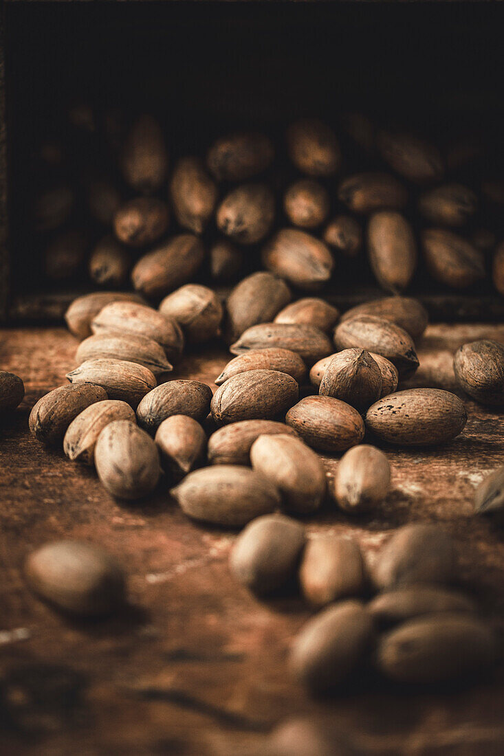 Whole pecans on a wooden background