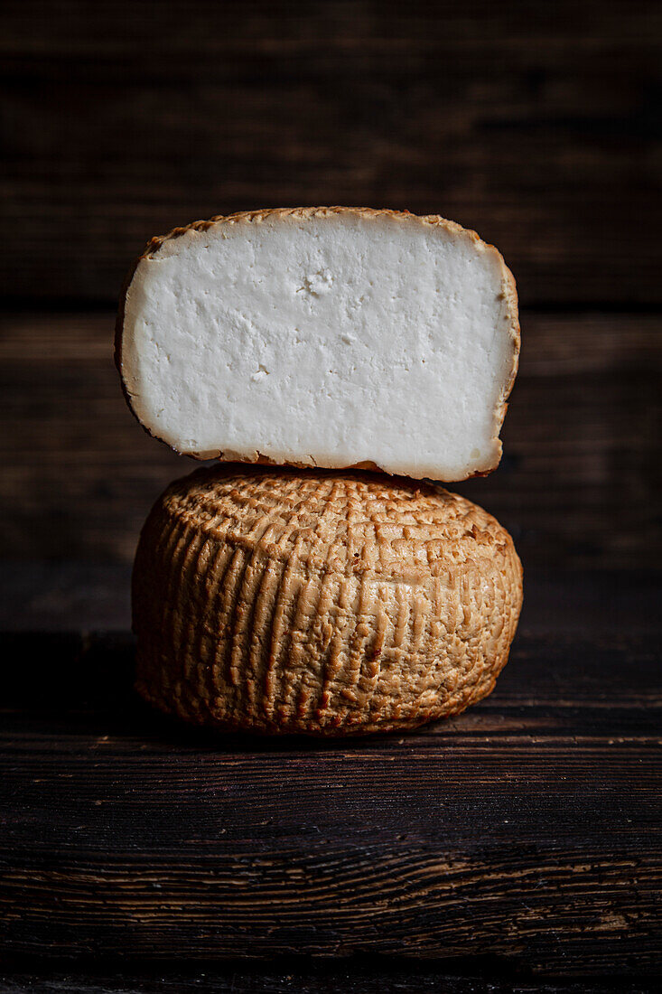 Smoked cheese against a a dark background with copy space
