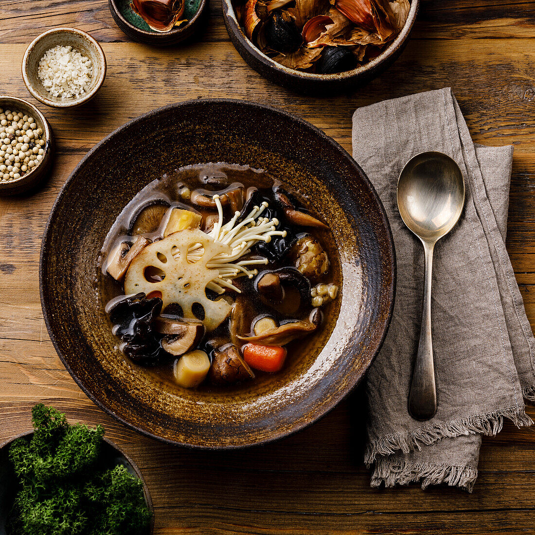 Healing soup with roots, mushrooms and barley on wooden table background