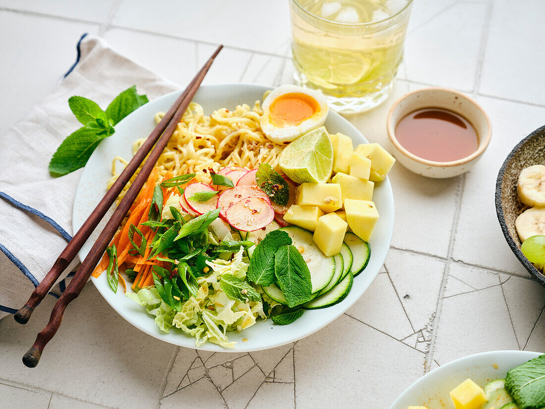 Salad Ramen - vegetarian dish with egg noodles, mango, lime and vegetables. Healthy pan-Asian cuisine