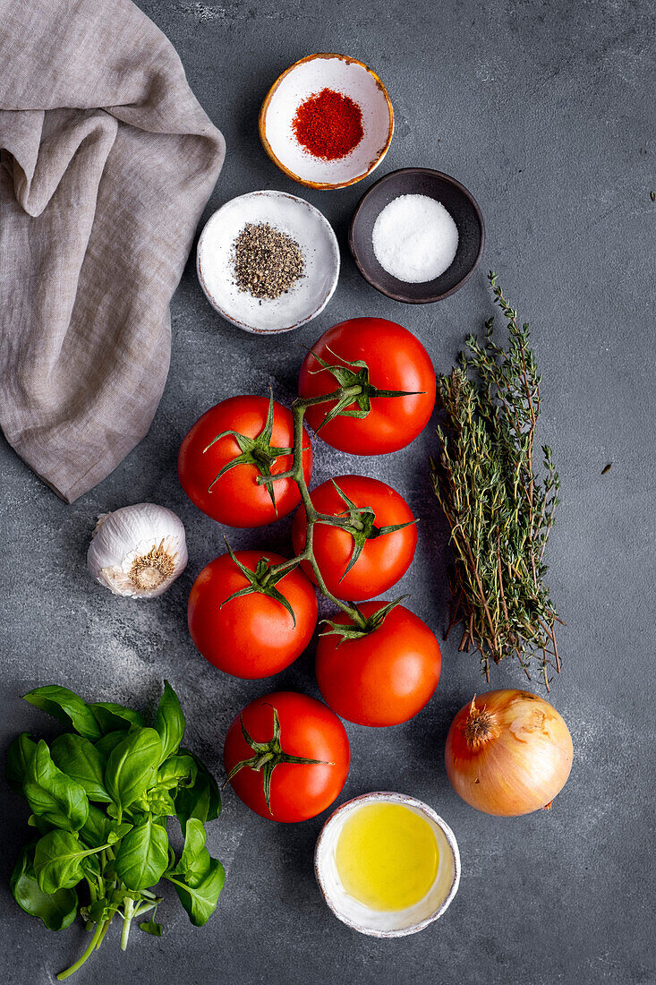 Tomato soup ingredients on a grey background
