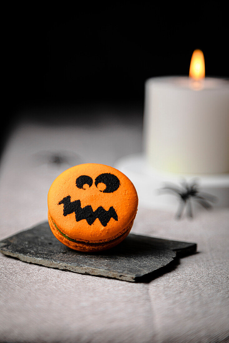 Jack-o-Lantern Macaron over table for Halloween