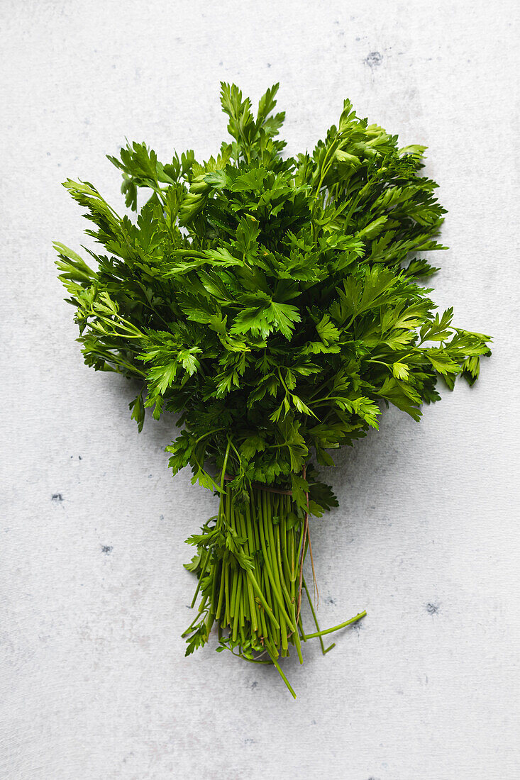 Bunch of parsley leaves over white background.