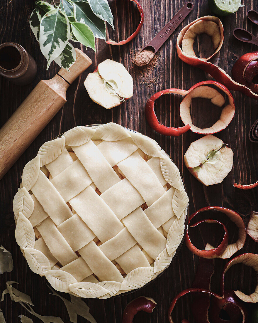 Red apple cake with lattice pattern baked on a rustic wooden table