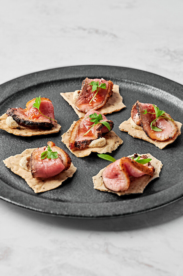 Duck breast, fennel seeds & black pepper cracker, macadamia mousse, orange glaze & chilli salt