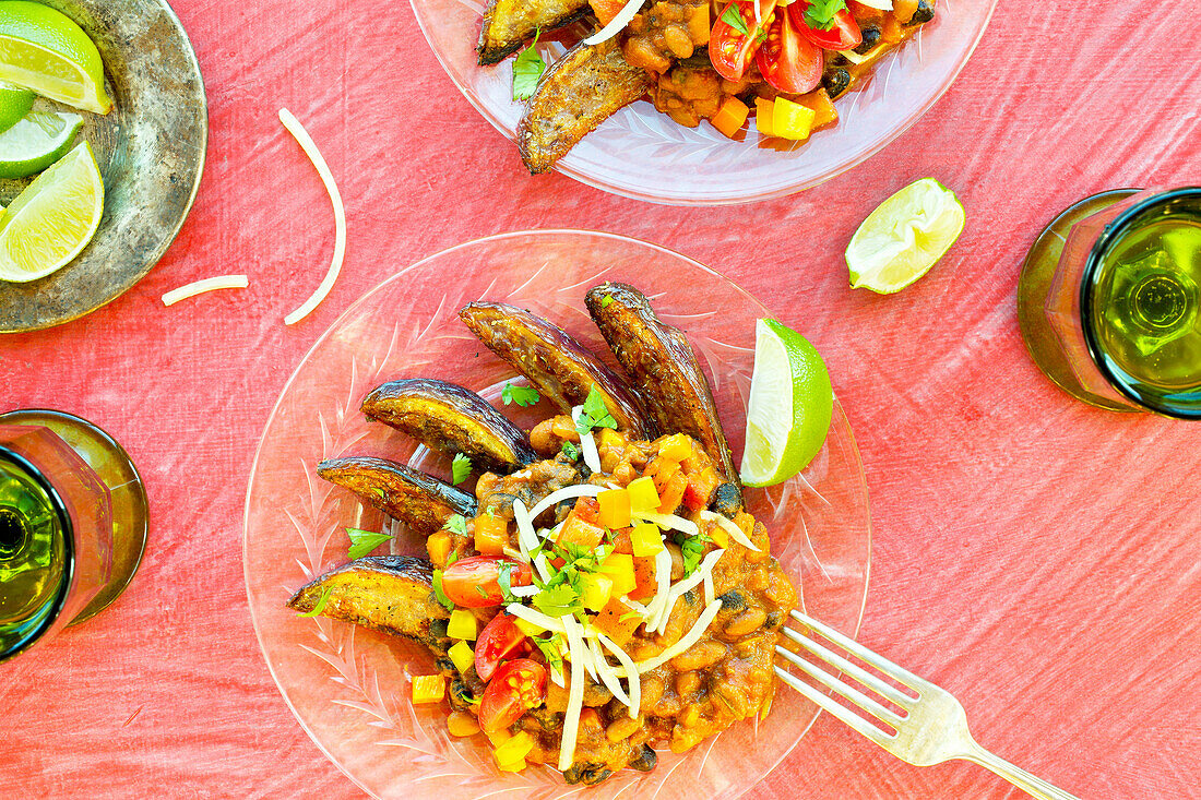 Vegetarian three-bean chilli fries on a pink background