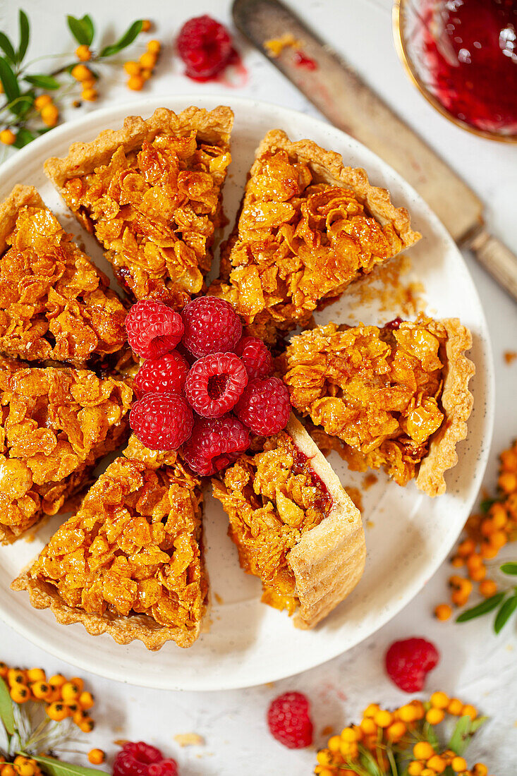 Sliced cornflake tart, served with fresh raspberries