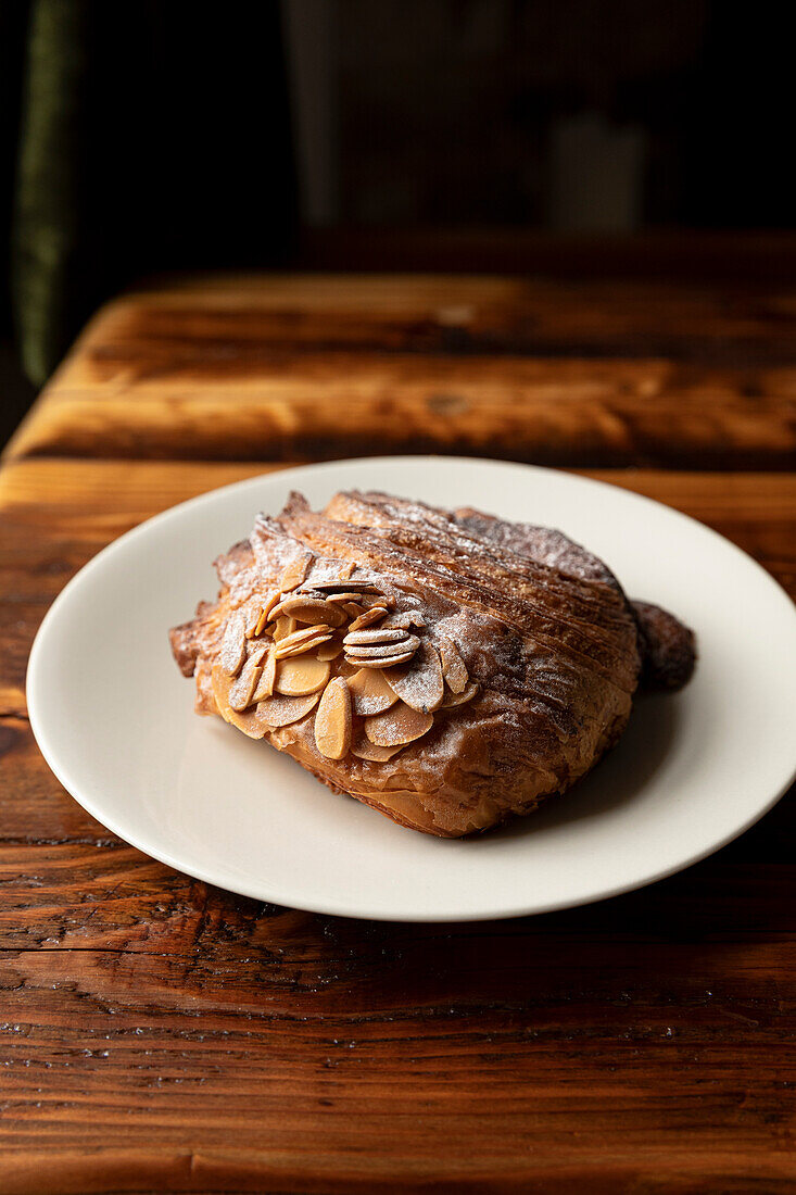 Almond croissant on a wooden table