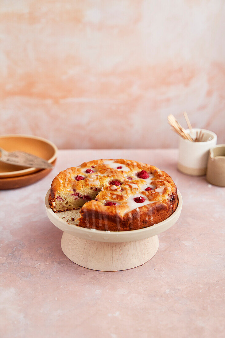 Raspberry and ricotta cake with icing on a stand