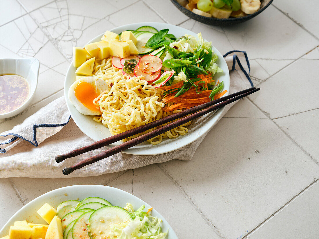 Salad Ramen - vegetarian dish with egg noodles, mango, lime and vegetables. Healthy pan-Asian cuisine